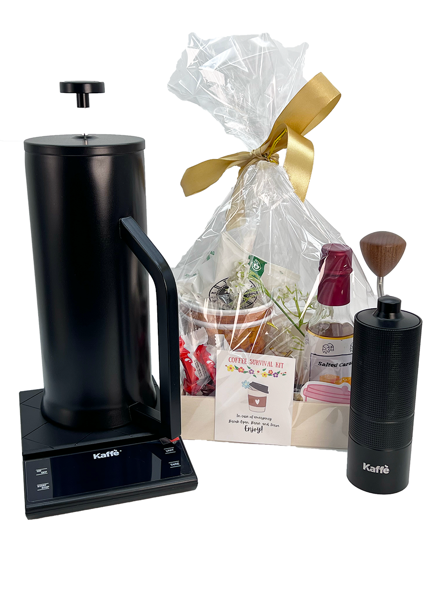Black coffee press, gift bag with a gold bow, and Kaffee branded items on a white background